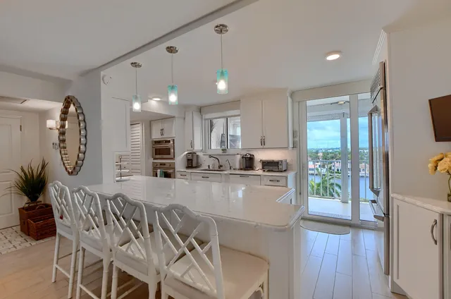 a large kitchen with a table and chairs