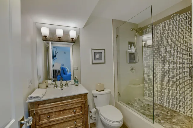 a bathroom with a sink toilet and shower