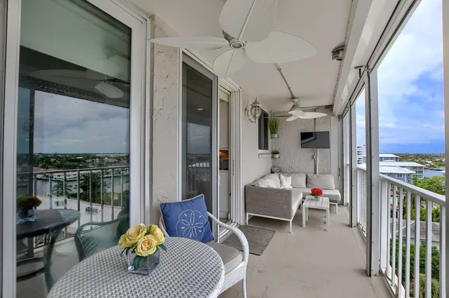 a living room with furniture and a floor to ceiling window