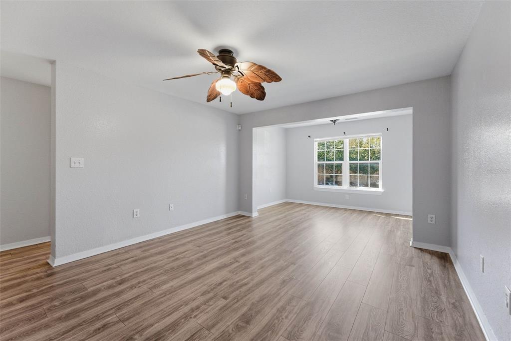 5479 Vineland Road, Unit 9202 Orlando, FL 32811 - Photo 13 of 31 wooden floor in an empty room with a window