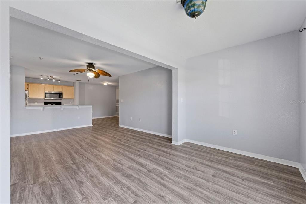 5479 Vineland Road, Unit 9202 Orlando, FL 32811 - Photo 15 of 31 a view of empty room with wooden floor and windows