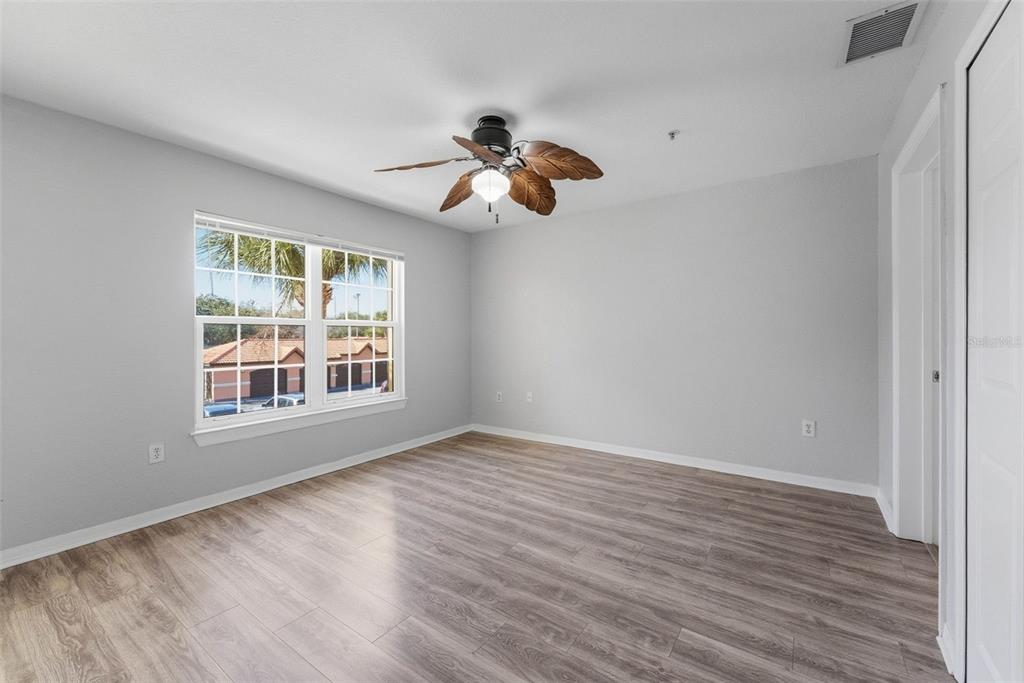 5479 Vineland Road, Unit 9202 Orlando, FL 32811 - Photo 19 of 31 a view of an empty room with wooden floor and a window