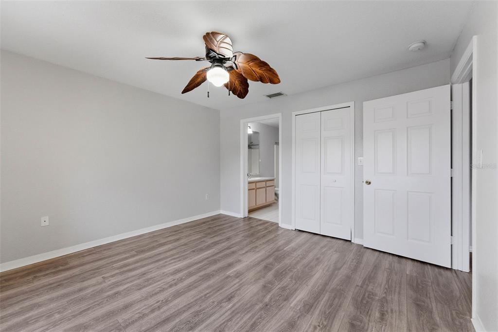 5479 Vineland Road, Unit 9202 Orlando, FL 32811 - Photo 20 of 31 a view of a room with wooden floor ceiling fan and window