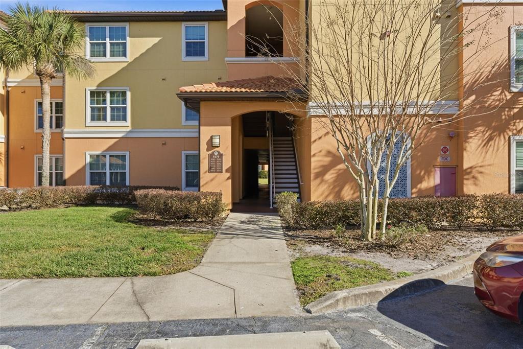 5479 Vineland Road, Unit 9202 Orlando, FL 32811 - Photo 2 of 31 a front view of a house with a yard