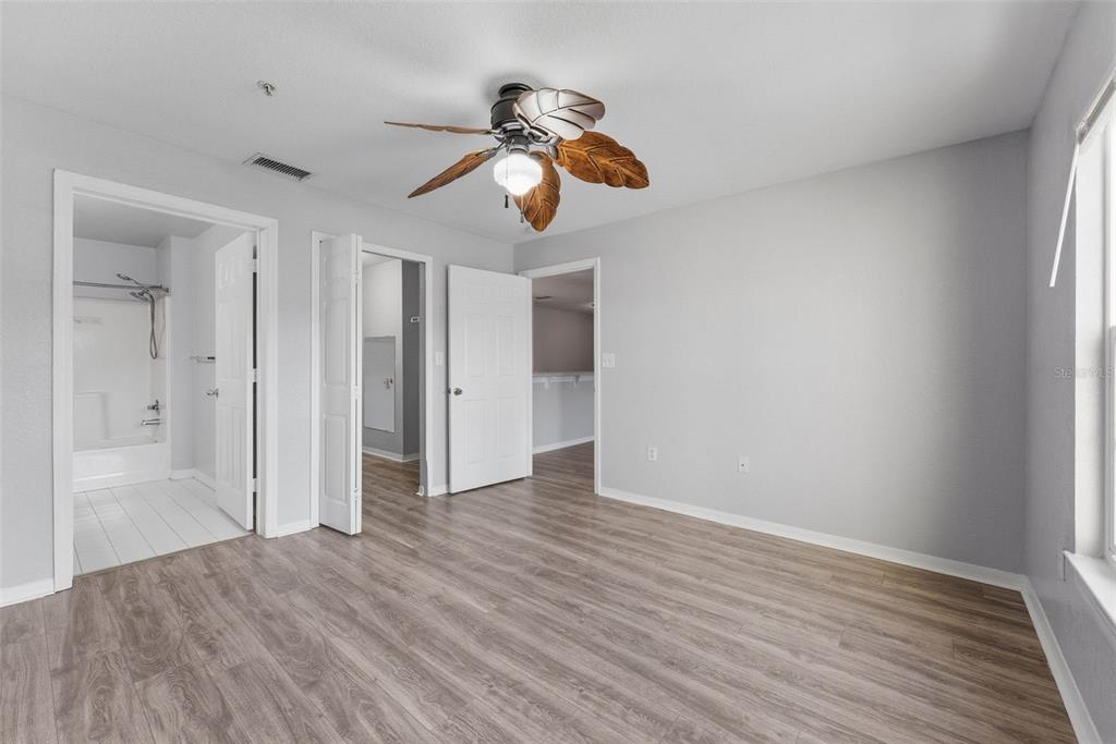 5479 Vineland Road, Unit 9202 Orlando, FL 32811 - Photo 21 of 31 wooden floor in an empty room with a window