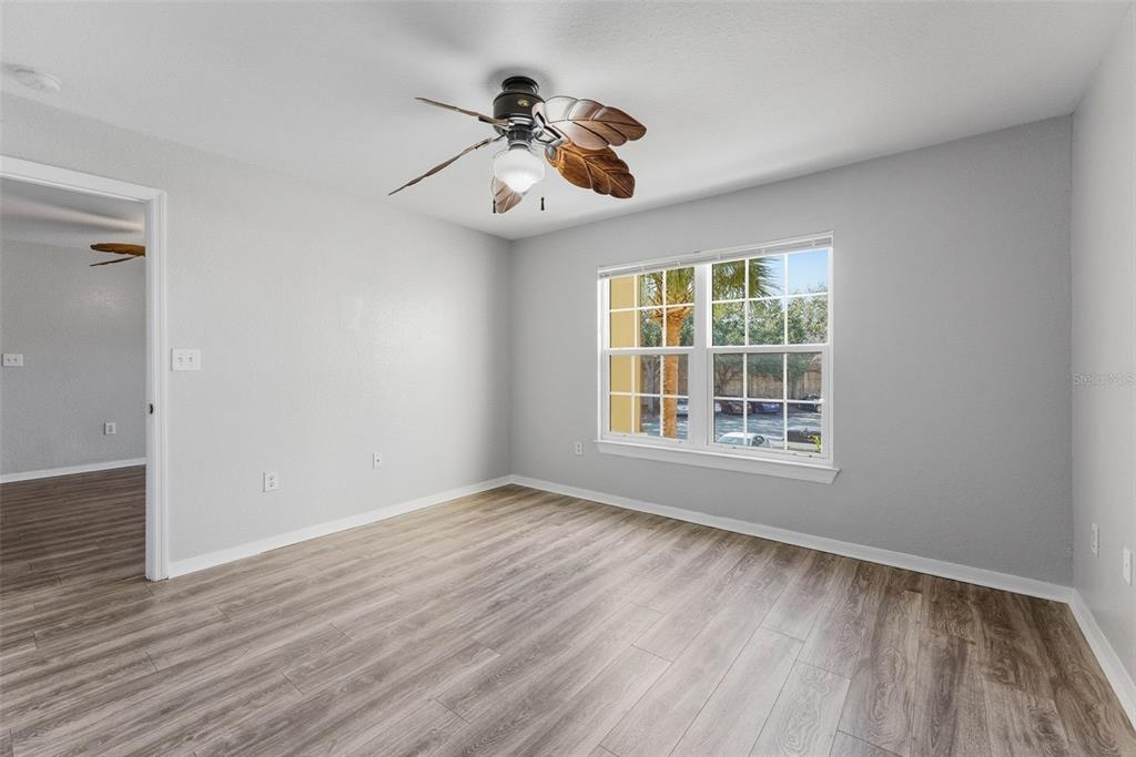 5479 Vineland Road, Unit 9202 Orlando, FL 32811 - Photo 25 of 31 a view of an empty room with wooden floor and a window