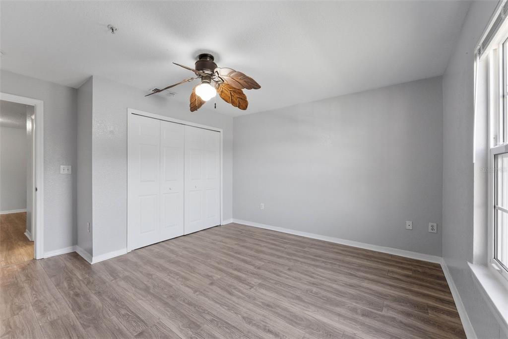 5479 Vineland Road, Unit 9202 Orlando, FL 32811 - Photo 29 of 31 a view of room with hardwood floor and window