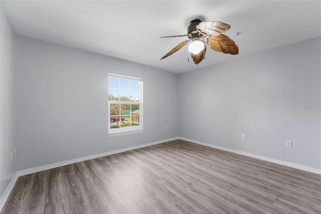 a view of room with window and wooden floor