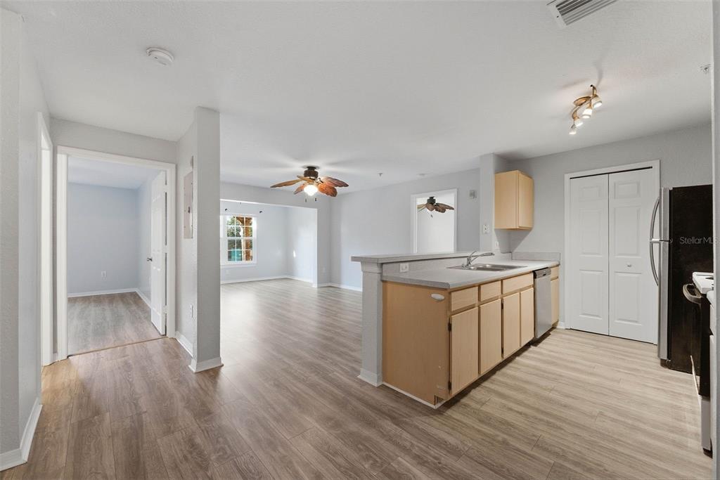 5479 Vineland Road, Unit 9202 Orlando, FL 32811 - Photo 5 of 31 a kitchen with a refrigerator and a stove top oven