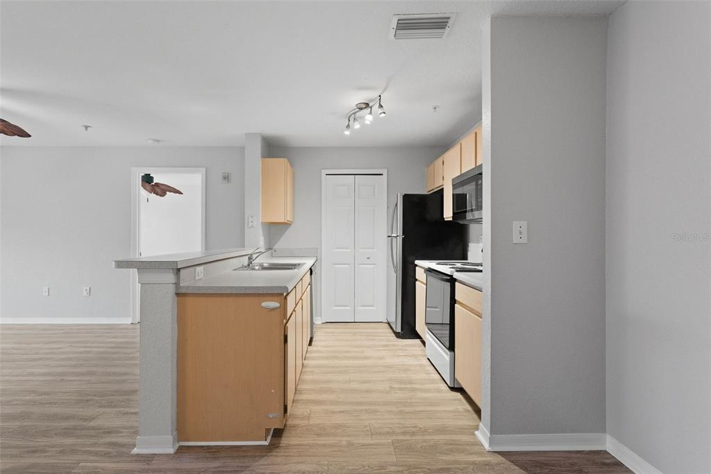 5479 Vineland Road, Unit 9202 Orlando, FL 32811 - Photo 6 of 31 a kitchen with stainless steel appliances granite countertop a refrigerator a stove and a sink