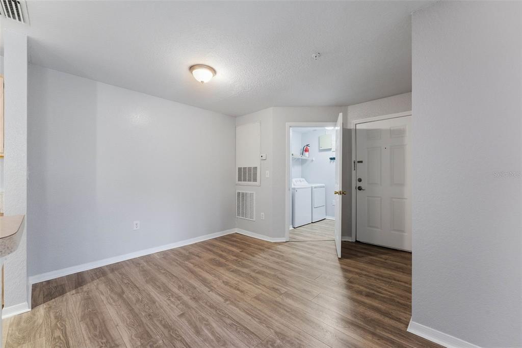 5479 Vineland Road, Unit 9202 Orlando, FL 32811 - Photo 10 of 31 a view of wooden floor in an empty room