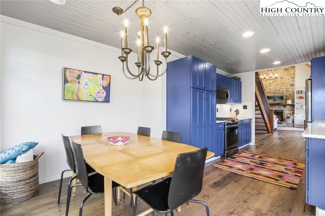 313 Birch Boone, NC 28607 - Photo 14 of 50 a view of a dining room with furniture a kitchen and chandelier