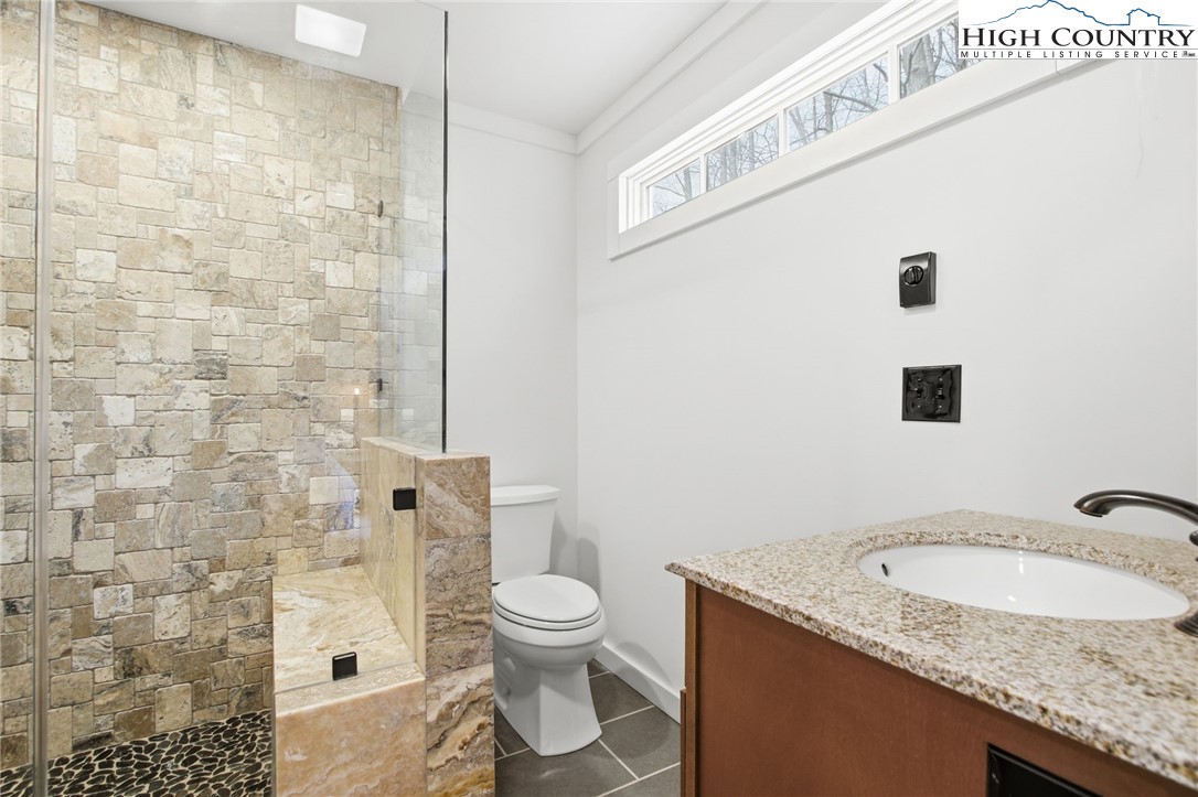 313 Birch Boone, NC 28607 - Photo 23 of 50 a bathroom with a granite countertop sink toilet and shower