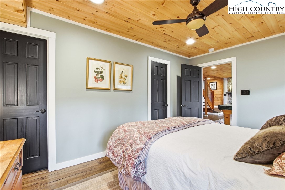 313 Birch Boone, NC 28607 - Photo 36 of 50 a large bedroom with wooden floor and ceiling fan