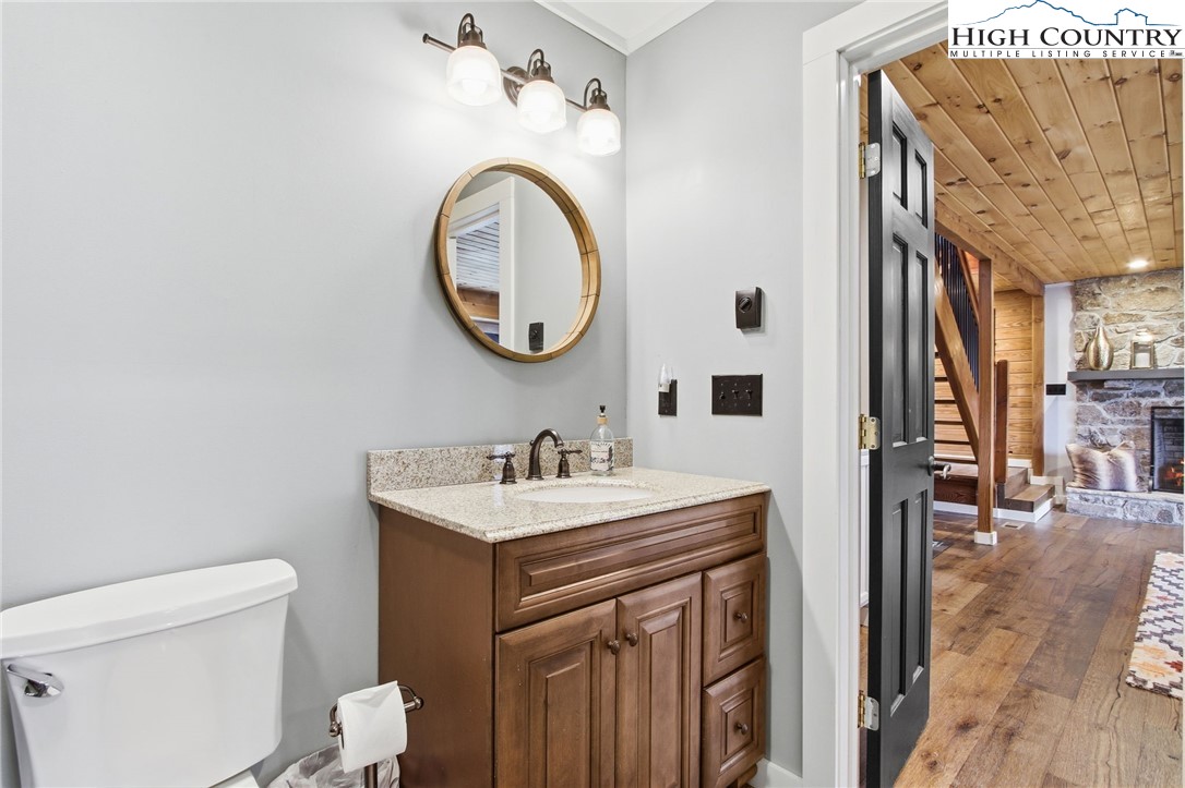 313 Birch Boone, NC 28607 - Photo 39 of 50 a bathroom with a sink a toilet and a mirror