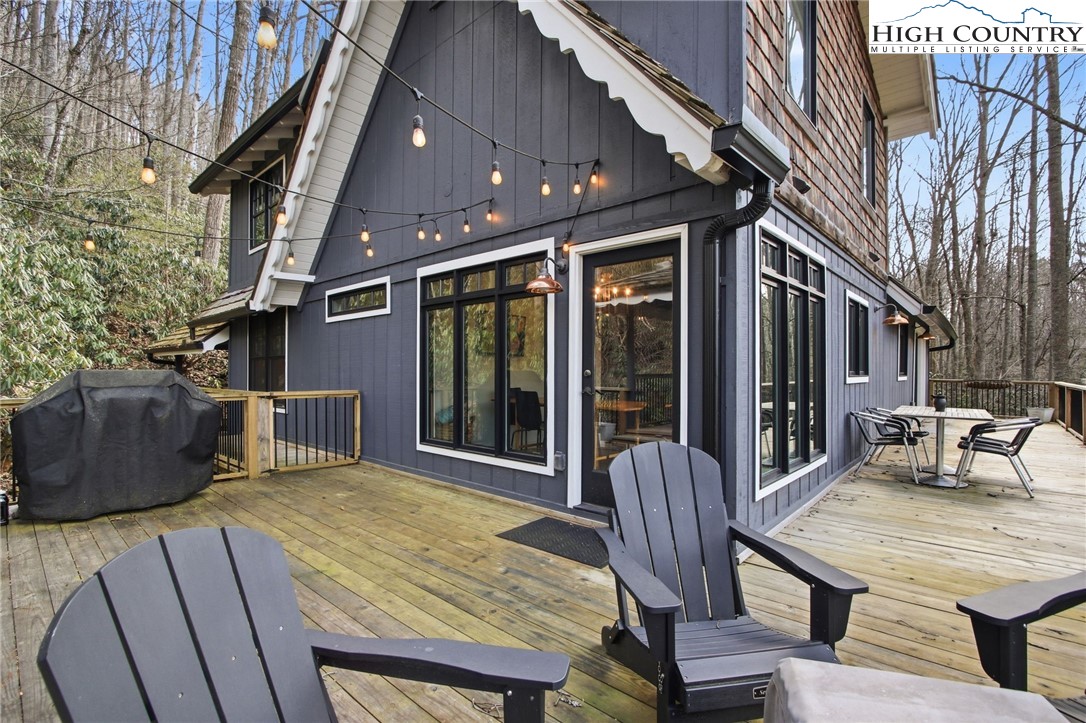 313 Birch Boone, NC 28607 - Photo 41 of 50 a view of a patio with table and chairs with wooden floor and fence