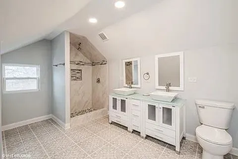 a bathroom with a toilet a sink and a mirror