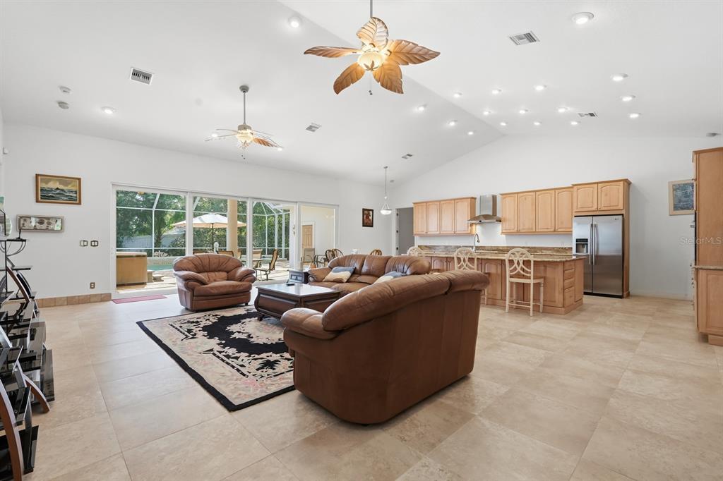 105 Beach Street Ponce Inlet, FL 32127 - Photo 15 of 67 a living room with furniture kitchen view and a large window