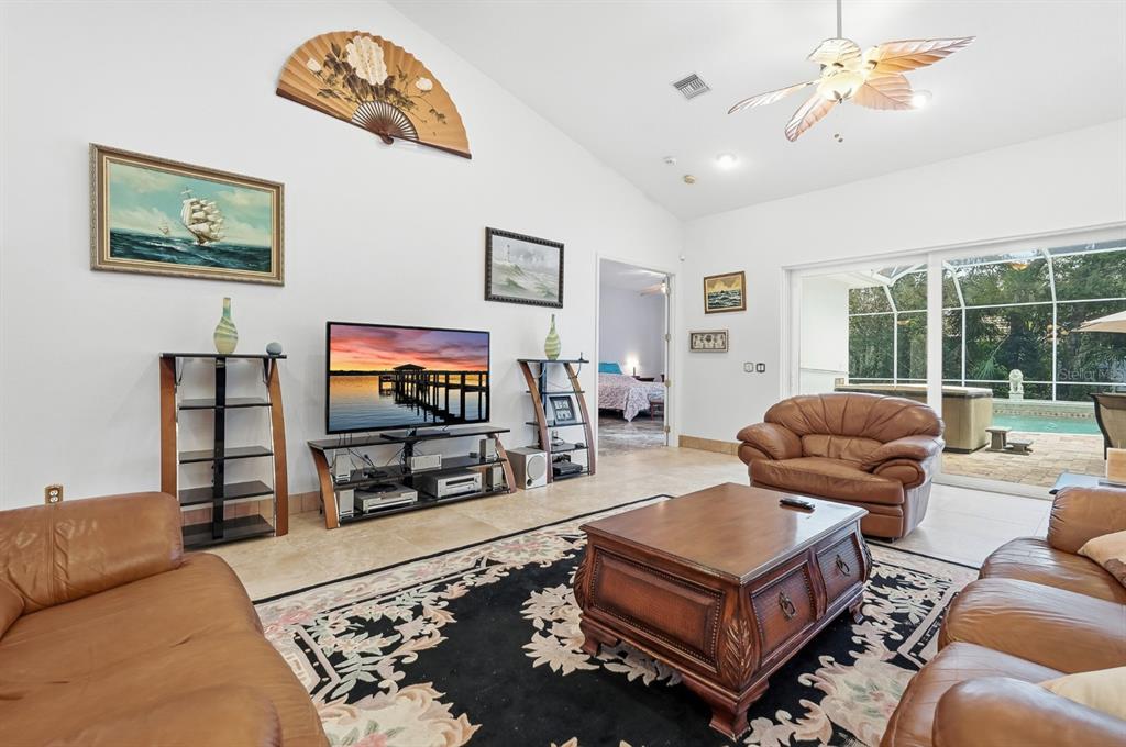 105 Beach Street Ponce Inlet, FL 32127 - Photo 18 of 67 a living room with furniture a flat screen tv and a large window