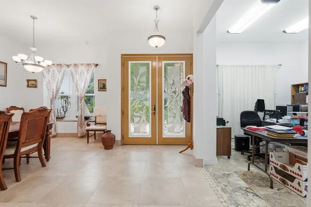 a living room with furniture kitchen view and a large window