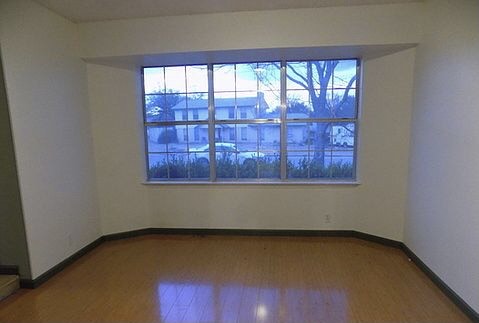 509 Meadowbrook Drive Georgetown, TX 78628 - Photo 13 of 17 A spacious room offers ample natural light through a large, paneled window.