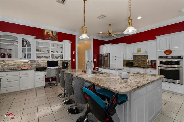 a kitchen with a stove a counter space a sink dishwasher and cabinets with wooden floor