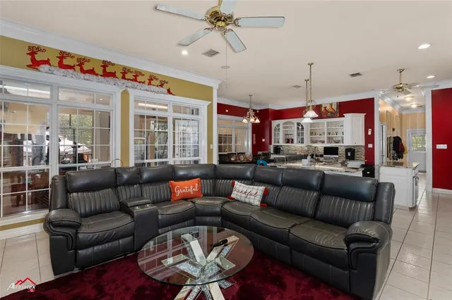 a living room with furniture a ceiling fan and a window