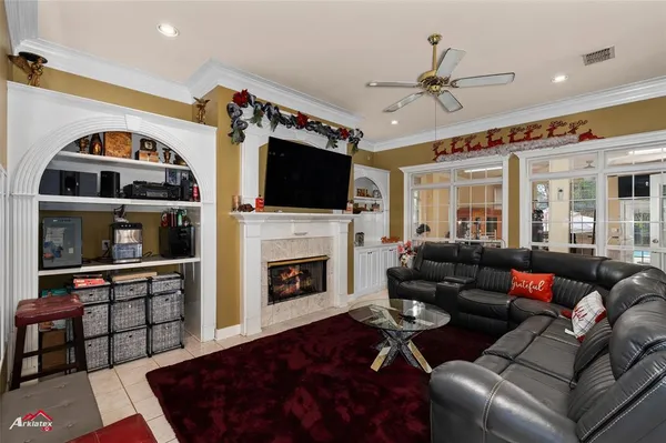 a living room with furniture a flat screen tv and a fireplace