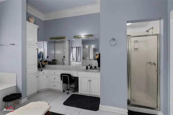 a kitchen with a sink a refrigerator a stove and white cabinets