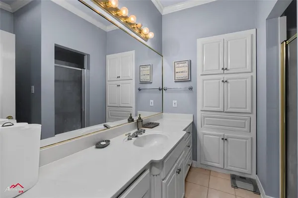 a bathroom with a sink double vanity and a mirror