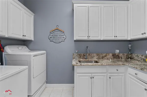 a view of cabinets with washer dryer and cabinets
