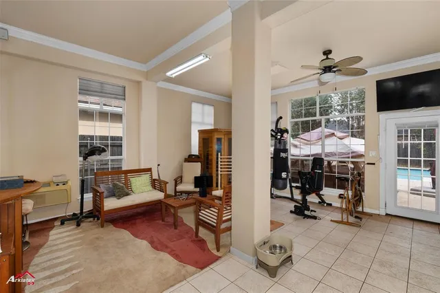 a living room with furniture a flat screen tv and floor to ceiling window