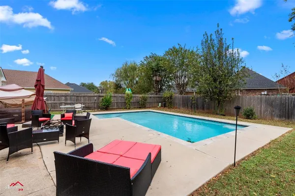 a view of swimming pool with outdoor seating