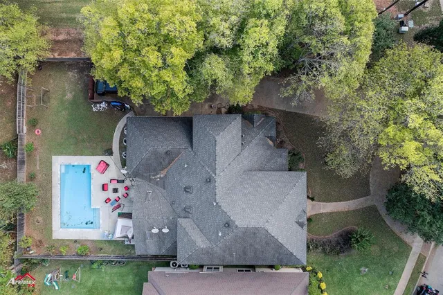 an aerial view of a house with a yard