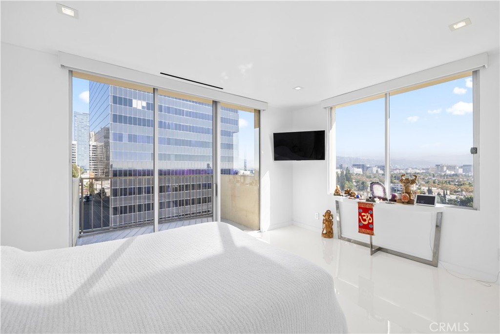 2160 Century Park East, Unit 902 Los Angeles, CA 90067 - Photo 19 of 51 a bedroom with a bed and a large window
