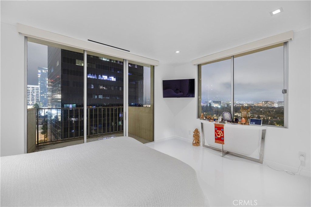 2160 Century Park East, Unit 902 Los Angeles, CA 90067 - Photo 20 of 51 a bedroom with a bed and a large window