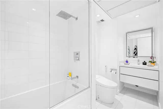 a bathroom with a sink toilet vanity and shower