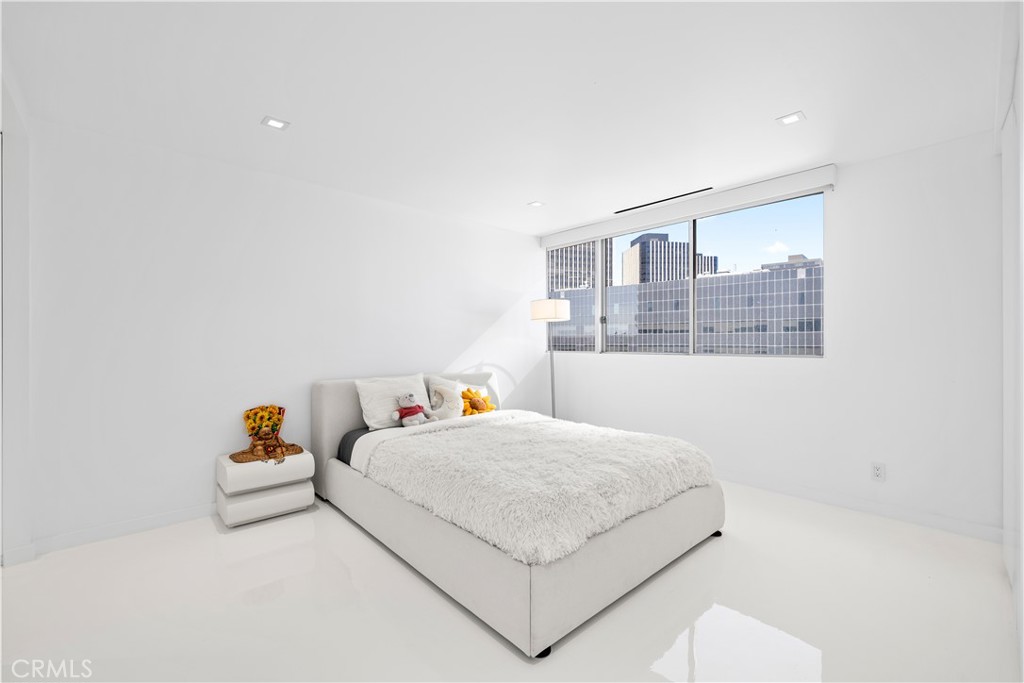 2160 Century Park East, Unit 902 Los Angeles, CA 90067 - Photo 29 of 51 a bedroom with a bed and a wall painting