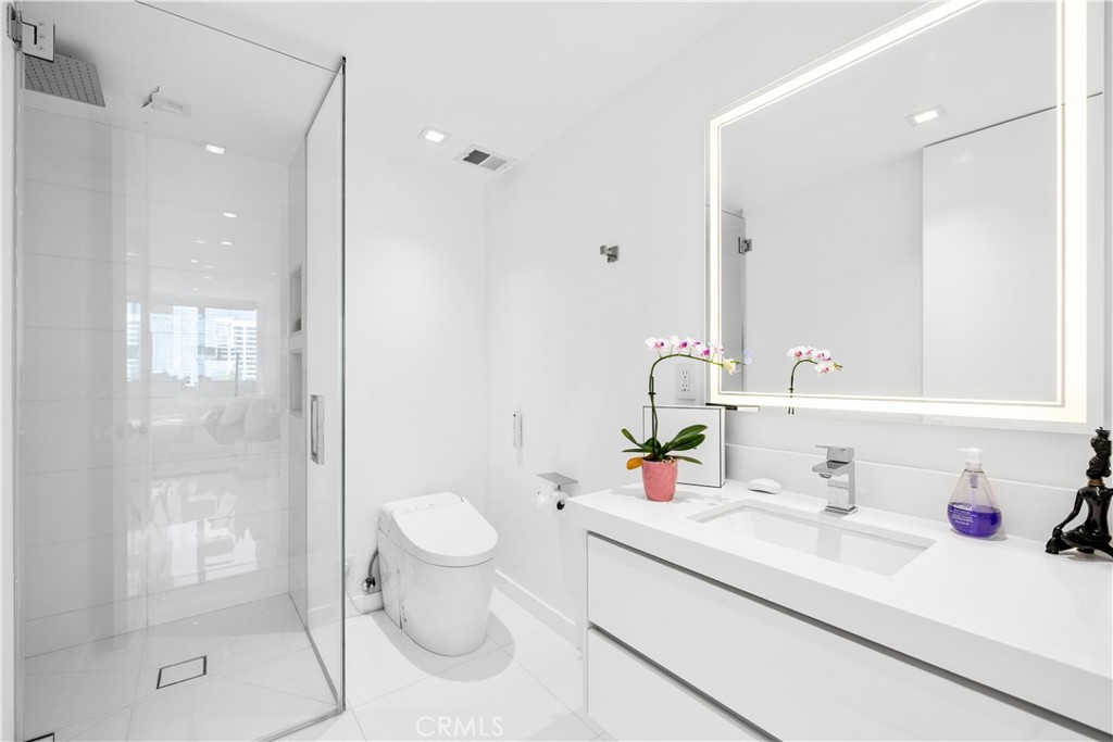 2160 Century Park East, Unit 902 Los Angeles, CA 90067 - Photo 32 of 51 a bathroom with a sink toilet vanity and shower