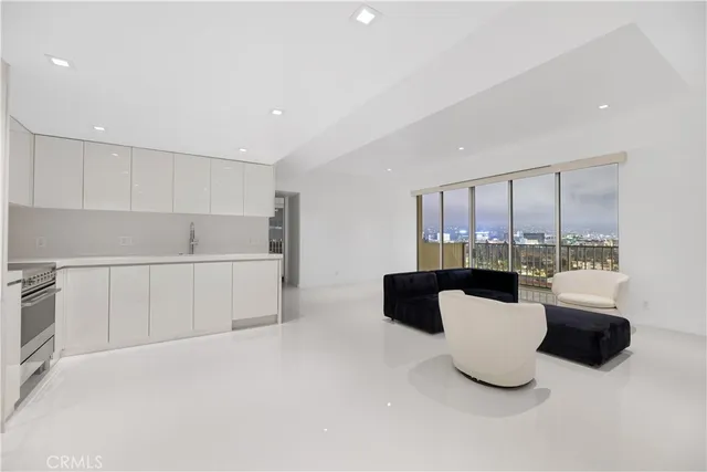 a kitchen with white cabinets and white appliances