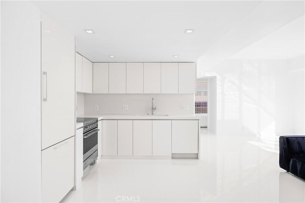 2160 Century Park East, Unit 902 Los Angeles, CA 90067 - Photo 7 of 51 a kitchen with white cabinets and white appliances