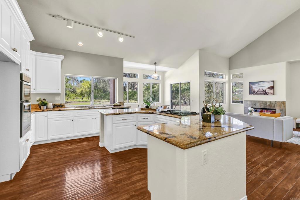 12236 Malabar Drive Poway, CA 92064 - Photo 15 of 32 a kitchen with counter top space sink and center island