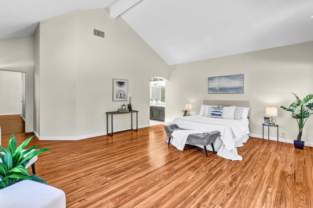 12236 Malabar Drive Poway, CA 92064 - Photo 17 of 32 a bedroom with a bed and wooden floor