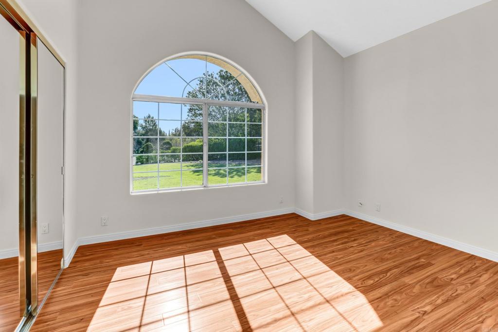 12236 Malabar Drive Poway, CA 92064 - Photo 20 of 32 a view of empty room with wooden floor and fan