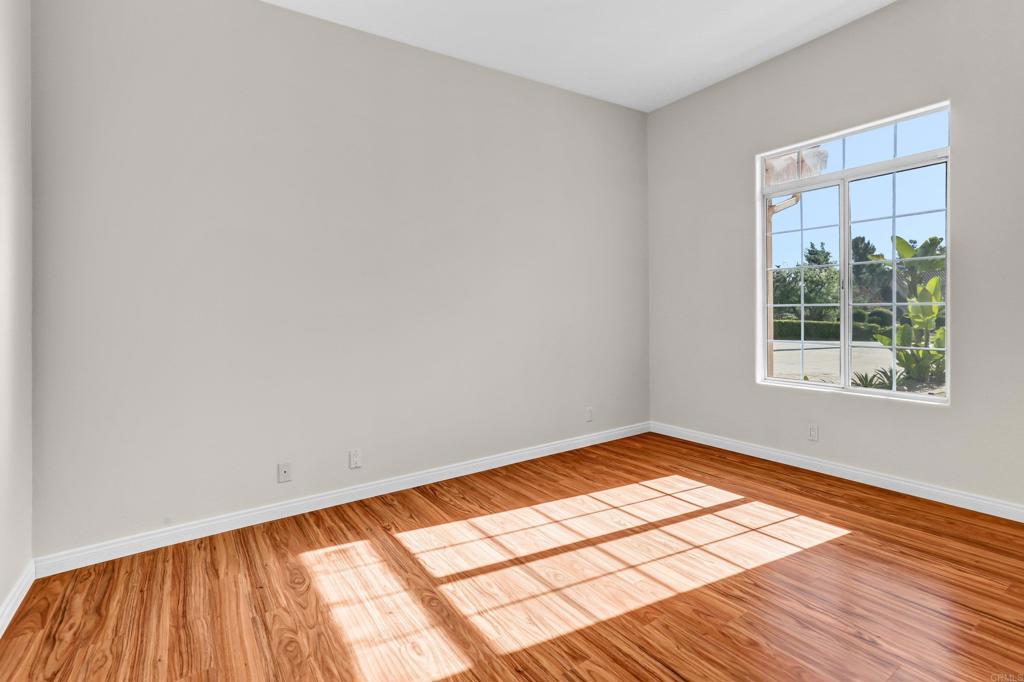 12236 Malabar Drive Poway, CA 92064 - Photo 22 of 32 an empty room with wooden floor and windows