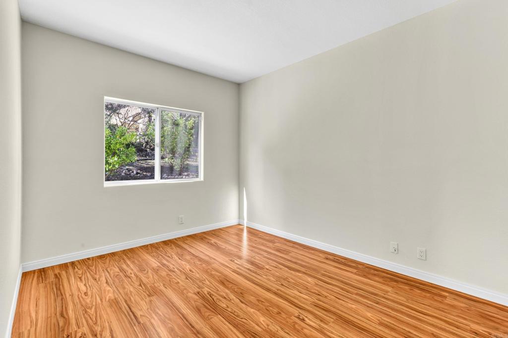12236 Malabar Drive Poway, CA 92064 - Photo 24 of 32 an empty room with wooden floor and windows