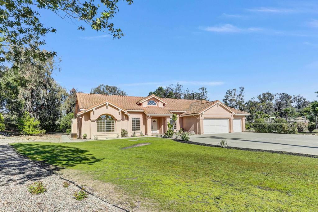 12236 Malabar Drive Poway, CA 92064 - Photo 3 of 32 a view of a white house with a big yard and potted plants in front of a house