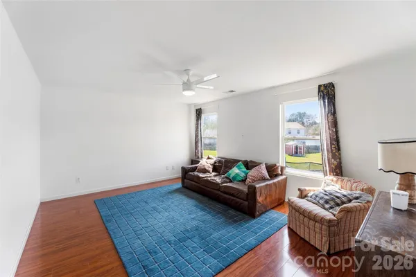 a living room with furniture rug and window