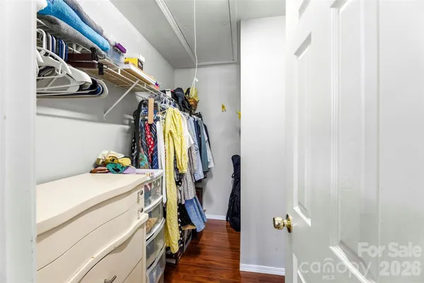 a view of walk in closet with clothes and shoes