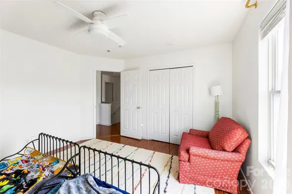 a bedroom with furniture and a window